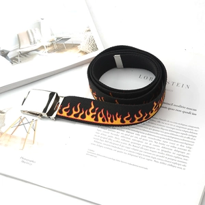 Men's black canvas belt with gradient fire pattern and silver metal buckle on magazine