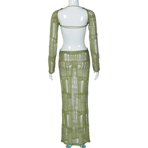 Detail of green knitted two-piece set featuring backless long sleeve top and maxi skirt