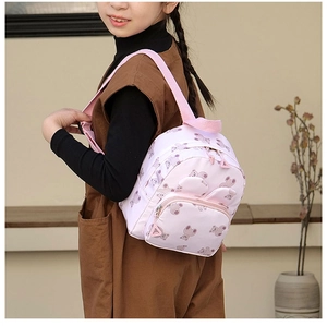 Pink cartoon bear backpack for kids featuring adjustable straps and front zipper pocket