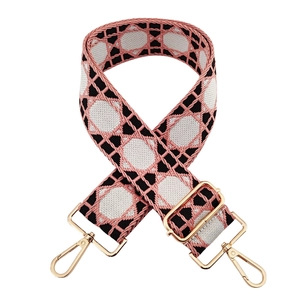 Detailed view of adjustable wide jacquard shoulder strap with pink and black geometric pattern