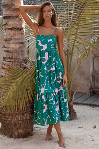 Detail of tiered tropical palm leaf print on a summer maxi dress with thin straps