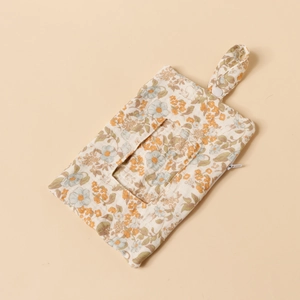 Detailed close-up of a floral cotton bedside hanging storage bag with zipper and button strap