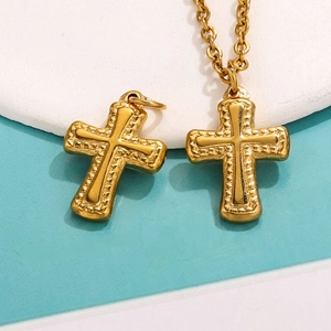 Textured gold stainless steel cross pendant with chain on a dual-tone background