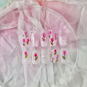 Detail of tulip press-on nails with 3D pearls and floral hand-painted designs