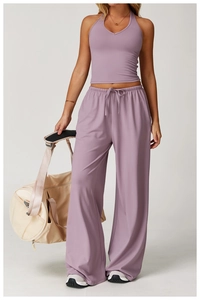 Side view of light purple yoga set featuring a halter tank top and high-waisted wide-leg pants