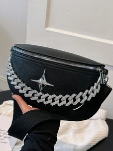 Detail of black lychee leather chest bag with silver star decor and rhinestone Cuban chain