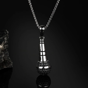 Detailed close-up of a black hip-hop microphone pendant with a twisted metal rope chain