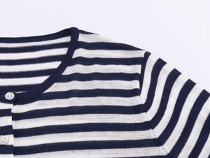 Detail of navy blue and white striped knit cardigan with round neck and white buttons