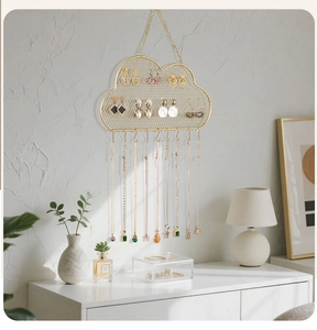 Cloud-shaped gold jewelry rack featuring fine metal mesh and hooks for earrings