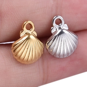 Minimalist 304 stainless steel seashell pendants in gold and silver finish shown on a finger