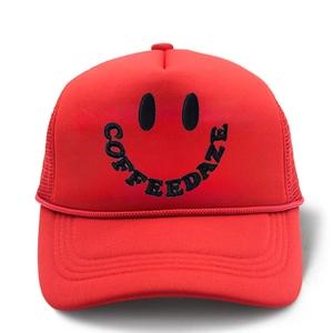 Detail of red trucker hat with black COFFEEDAZE smiley face embroidery and mesh back