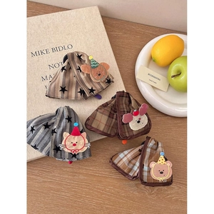 Cute cartoon animal hair clips with plaid and star patterns on wooden desk setup