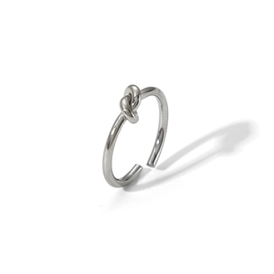 Detailed close-up of polished knot design on an adjustable silver stainless steel ring