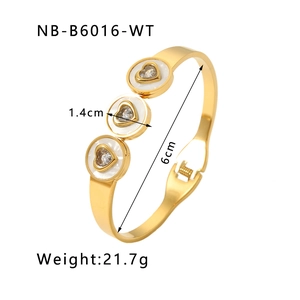 Detailed view of gold bangle showing 1.4cm shell discs with heart-shaped cubic zirconia