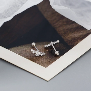 Macro shot of silver S925 cloud-shaped zircon earrings with screw-back fasteners