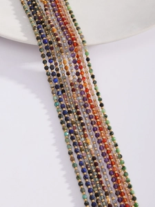 Macro shot of colorful natural faceted stone beaded necklaces with gold metal spacers
