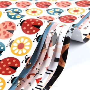 Colorful cartoon gift wrapping paper with ladybug and floral patterns in fan-shaped layout