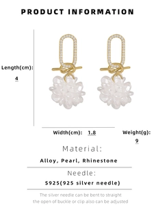 Detailed view of gold flower drop earrings with rhinestones and translucent petals