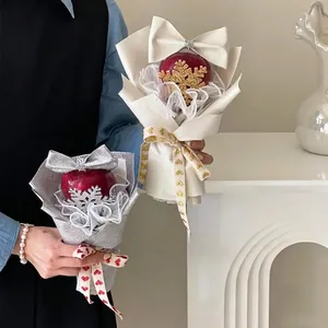 Golden and silver Christmas apple gift boxes with snowflake decor and elegant bows