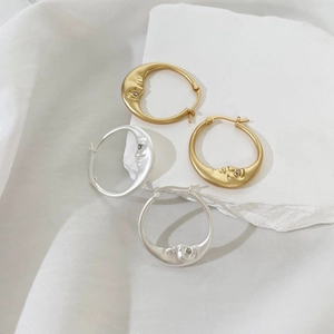 Minimalist moon face hoop earrings in gold and silver finish with rhinestone eyes
