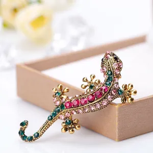 Exquisite gold lizard brooch set with vibrant pink rhinestones and green gemstone eyes