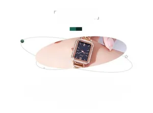 Detail of elegant rectangular rose gold watch with diamond bezel and starry dial