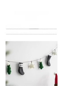 Detail of knitted Christmas bunting featuring stars and socks in Nordic minimalist style