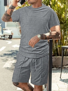 Detail of grey men's short sleeve set featuring 3D square jacquard knit texture fabric