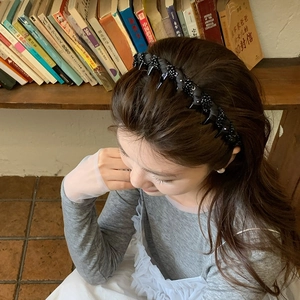 Black mesh headband with crystal beads and metal spikes for a punk high-volume hairstyle