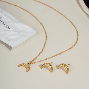 Golden crescent moon necklace and earring set with shimmering cubic zirconia stones