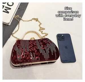 Detailed view of burgundy sequined evening clutch with gold handle and size comparison