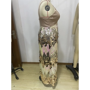 Detailed view of shimmering oversized sequins and champagne satin fabric of the formal gown