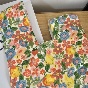 Close-up of floral cotton canvas wristlet bag with lemon and strawberry patterns