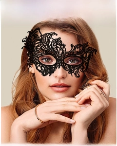 Close-up of elegant black lace masquerade mask with intricate hollow-out floral patterns