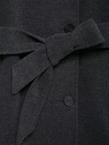 Detail of dark gray wool coat showing the twill texture and tied belt with resin button