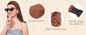Detail showing soft satin fabric texture and classic knotted design on brown headband