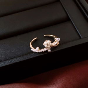 Macro detail of 14K gold plated ring featuring white pearls and camellia flower