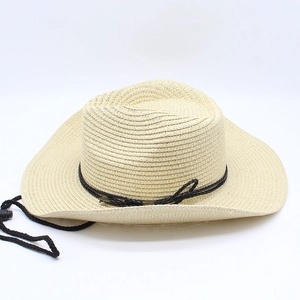Detail of western straw hat featuring a black woven band and adjustable chin strap