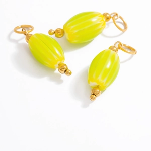 Oval glass pendant with lemon yellow and green stripes on a gold metal ring