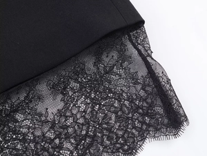 Close-up detail of the intricate black lace splicing on this elegant fashion dress