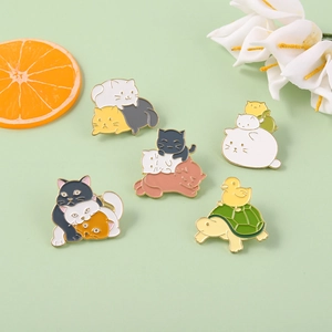 Detailed view of colorful stackable cat enamel pins with floral and citrus accents