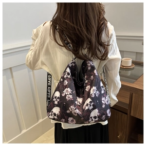 Detail of floral skull pattern tote bag with LOVE printed wide shoulder strap