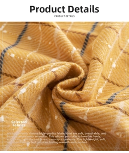 Close-up of soft plaid scarf fabric showing warm yellow diagonal weave and texture