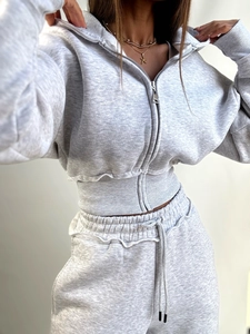 Women's light grey two-piece set featuring a cropped zip-up hoodie and drawstring joggers
