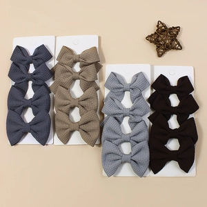 Detailed waffle texture ribbon hair bows in blue, khaki, grey, and coffee set on a card
