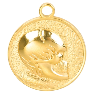 Macro detail of 18k gold plated stainless steel skull pendant with textured edges