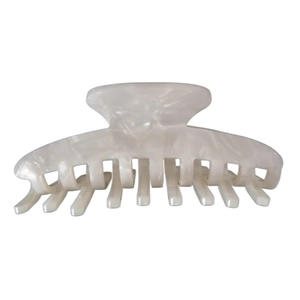 Close-up of cream white acetate hair claw clip with a glossy shell-like texture and finish