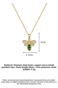 Macro detail of bee pendant with green gemstone and zircon pavé on gold chain