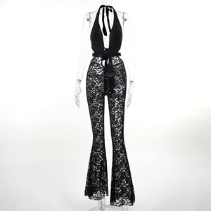 Detail of black lace halter neck jumpsuit with deep V-neck and sheer floral patterns