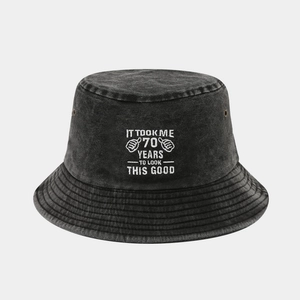 Detail of embroidered 'IT TOOK ME 70 YEARS' text on washed cotton bucket hat